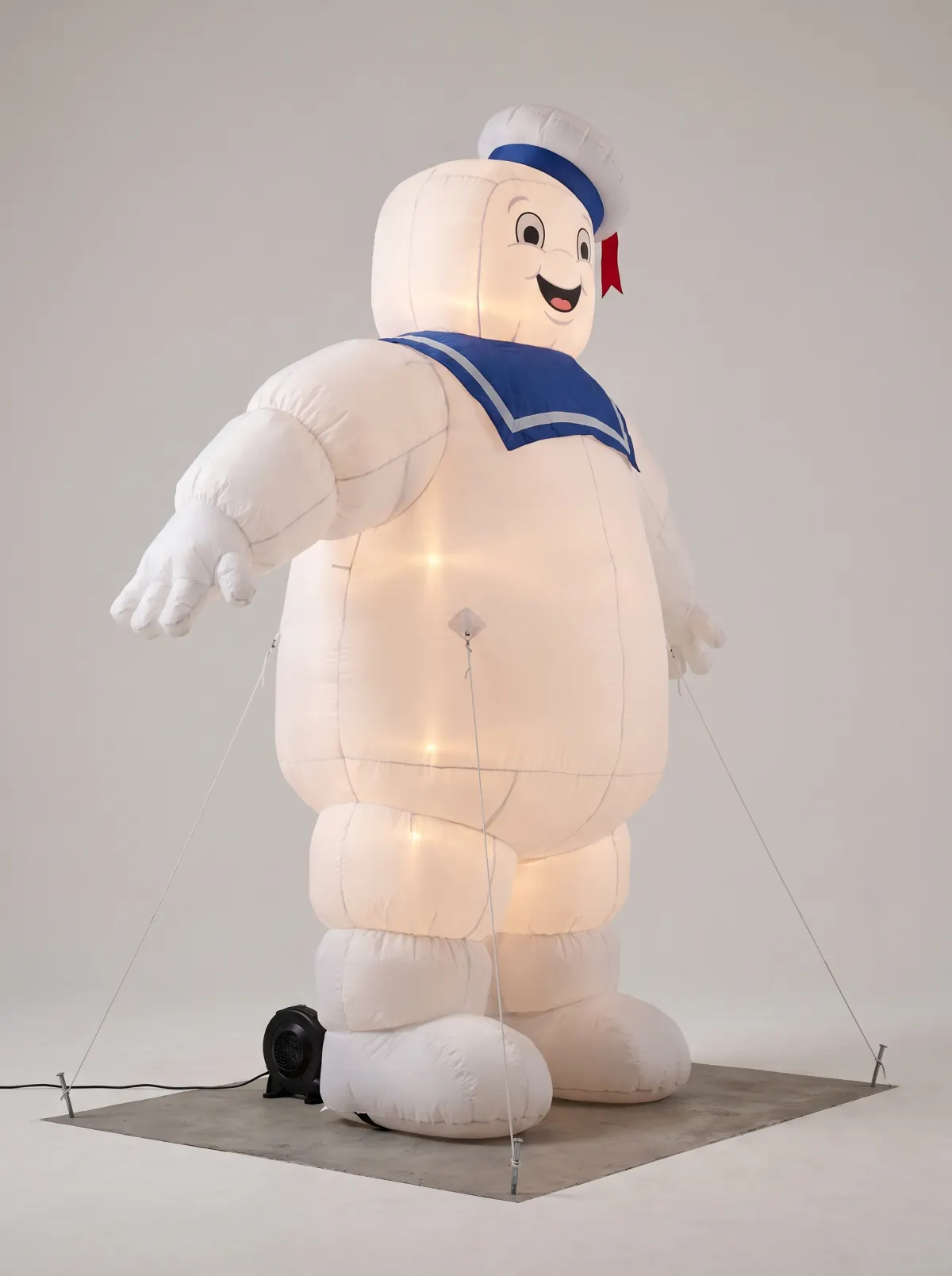 Initial isolated concept of a commercial 50-foot Stay Puft inflatable with visible seams, blower, anchors, and tie-down lines.